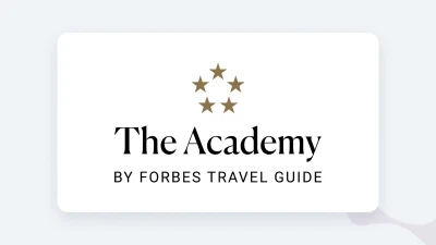 The Academy by Forbes Travel Guide logo